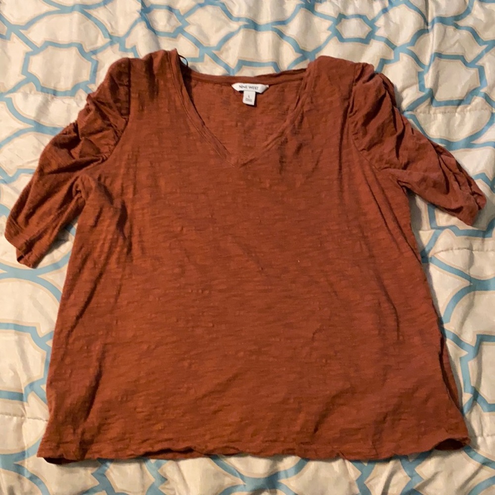 I’m selling a Large Nine West Maple brown shirt.